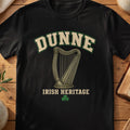 Dunne Irish harp T-shirt in Black, with cream surname lettering, a gold-toned harp, green shamrock and “Irish Heritage” text.