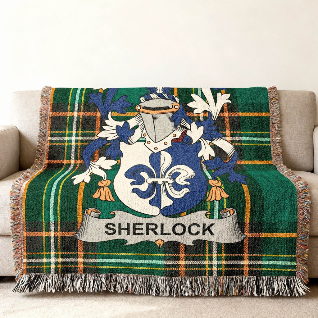 Sherlock family crest on a green tartan plaid throw blanket.