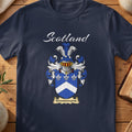 Navy Kinninmond family shield T-shirt featuring a white chevron and fleurs-de-lis on blue