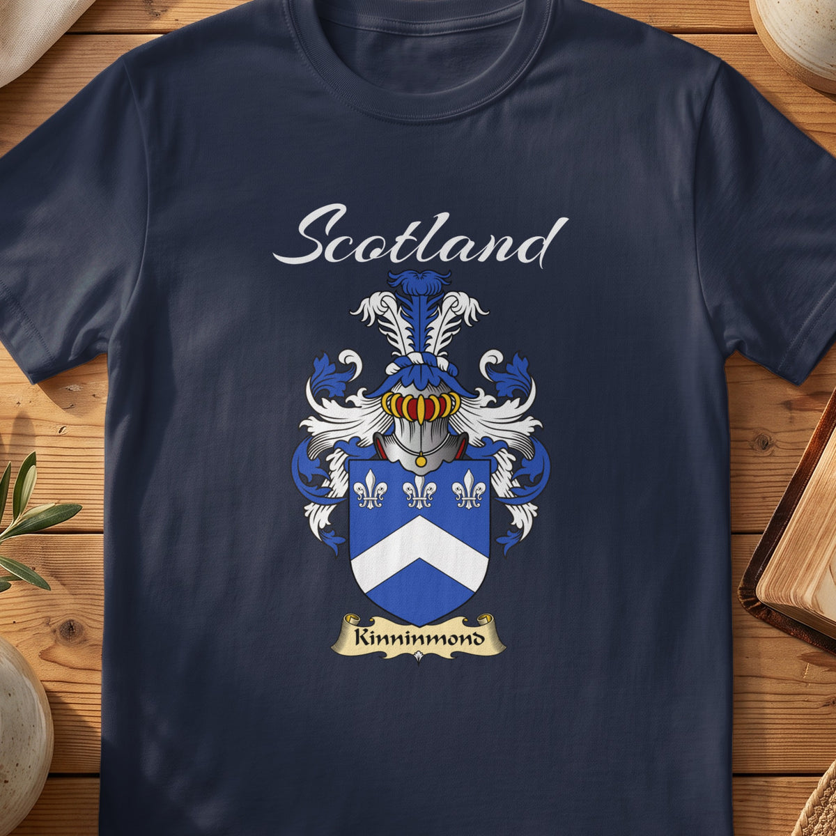 Navy Kinninmond family shield T-shirt featuring a white chevron and fleurs-de-lis on blue