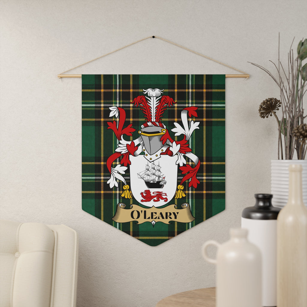 O'Leary family crest on green tartan banner hanging on textured wall.