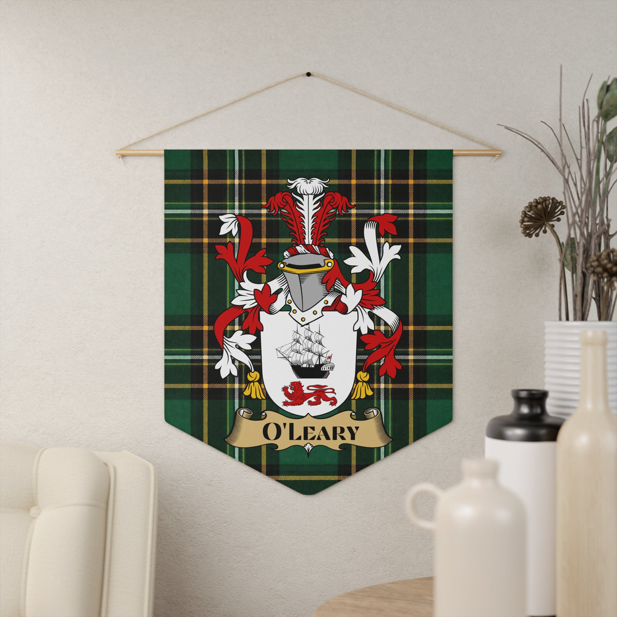 O'Leary family crest on green tartan banner hanging on textured wall.