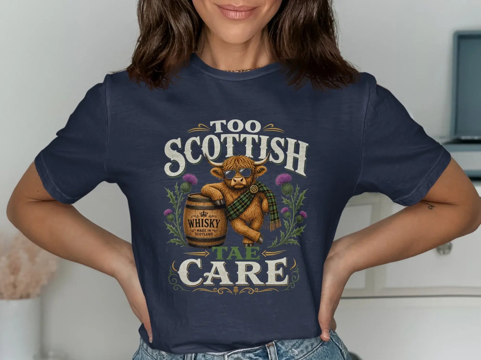 Navy t-shirt with a Highland cow wearing sunglasses and a tartan scarf.