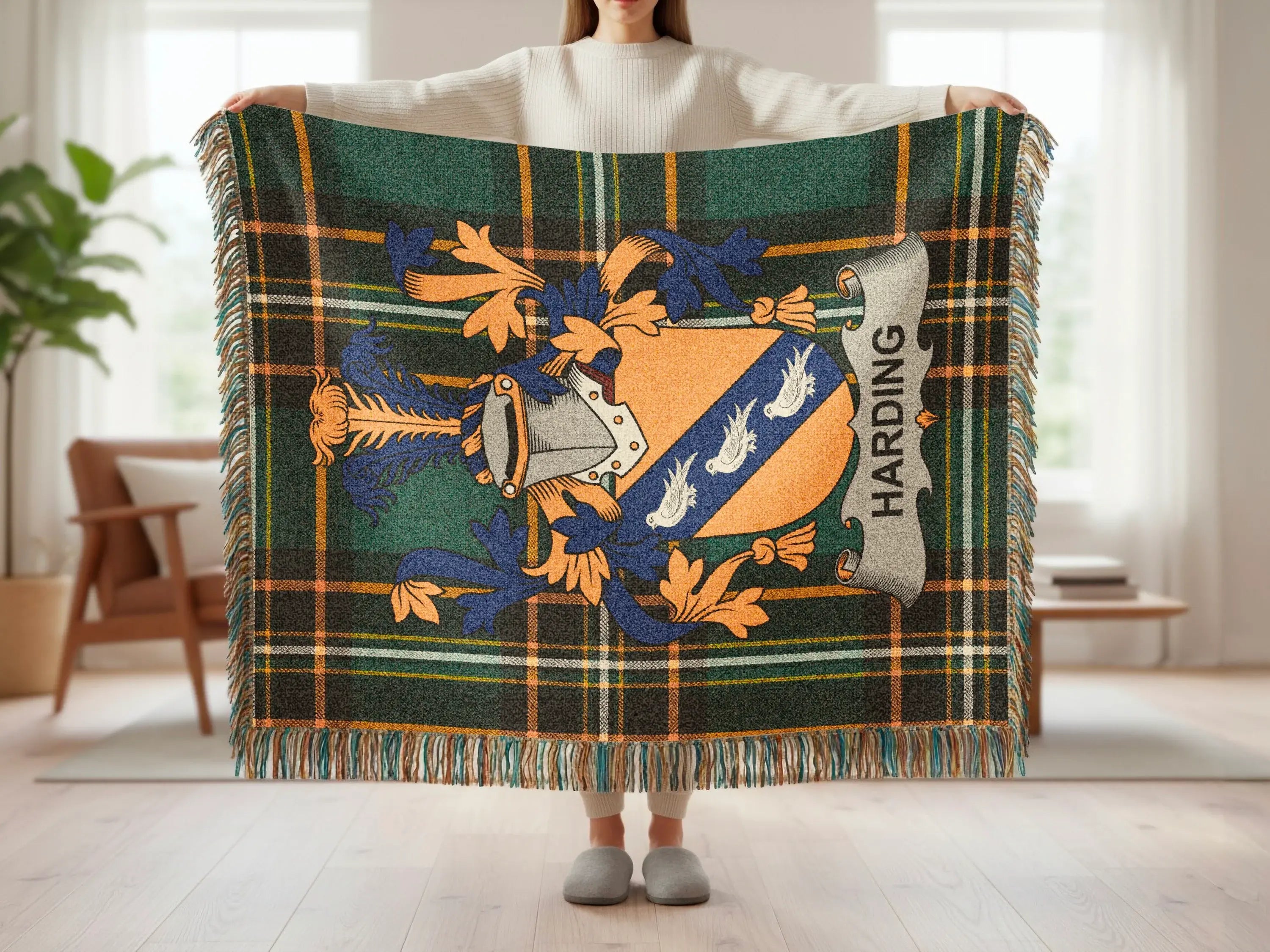 Tartan blanket with Harding family crest and fringe, held by a person.