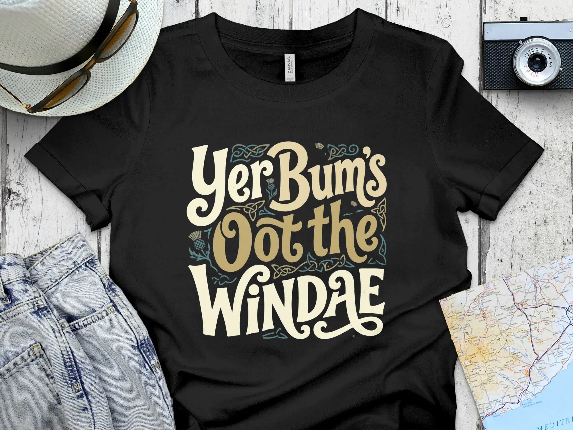 Black t-shirt with "Yer Bum's Oot the WINDAE" text in cream and yellow.