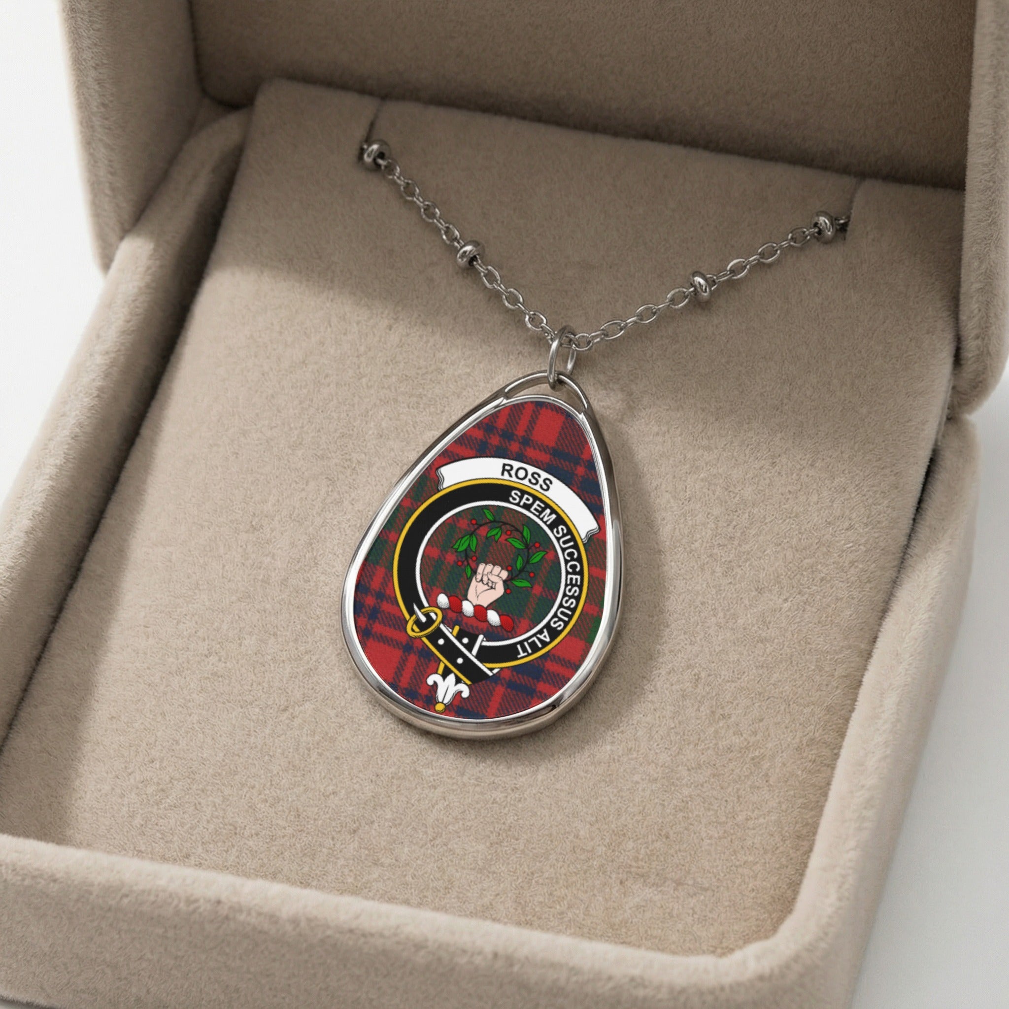 Silver oval pendant with Ross tartan and crest in a velvet box.