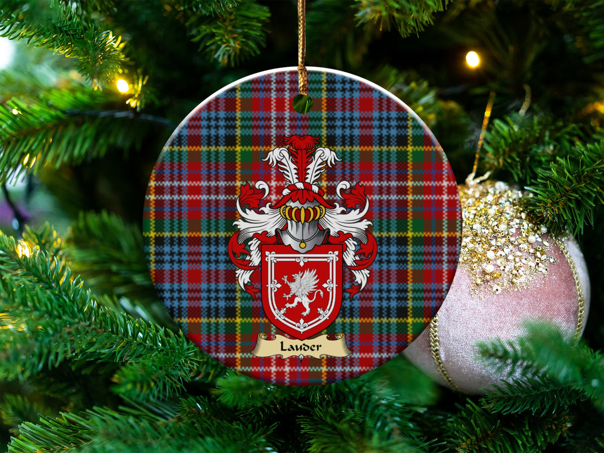 Lauder Scottish clan ceramic ornament with family crest on a Caledonia tartan background, hanging on a Christmas tree