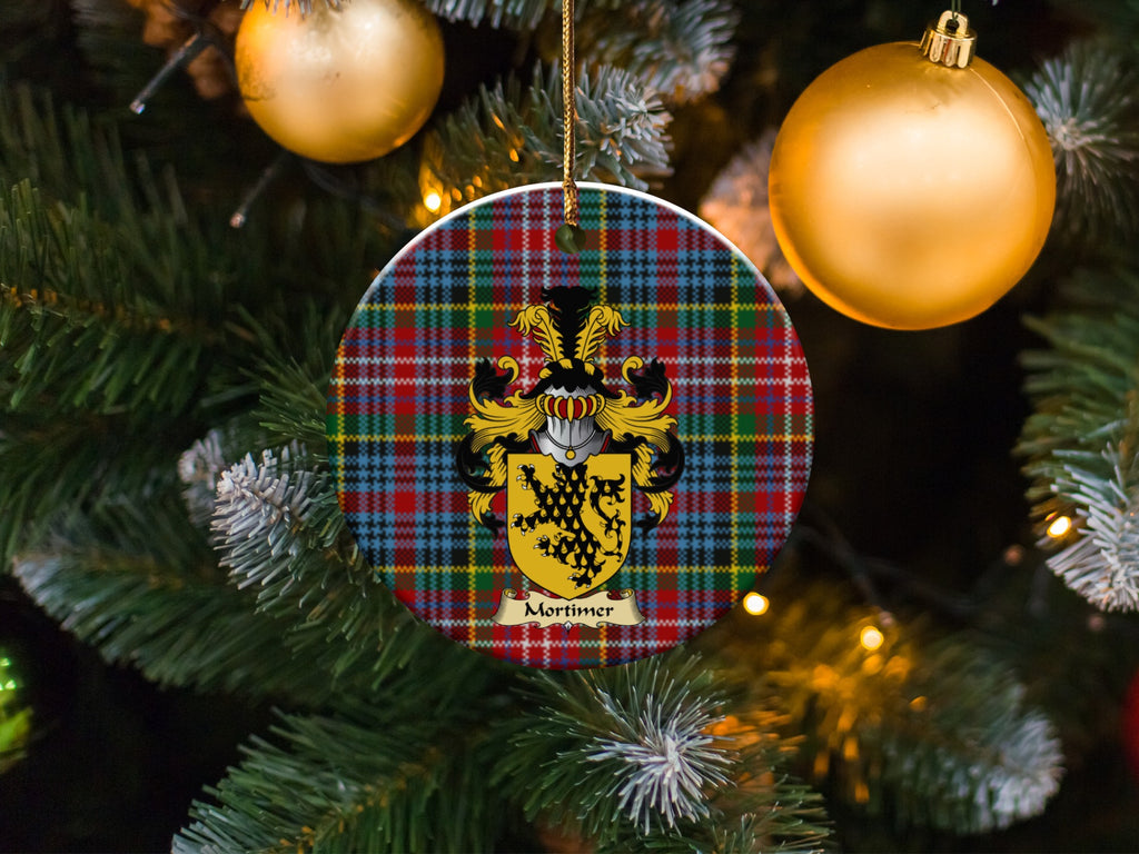 Mortimer family emblem ceramic Christmas ornament with Caledonia tartan background in festive holiday décor