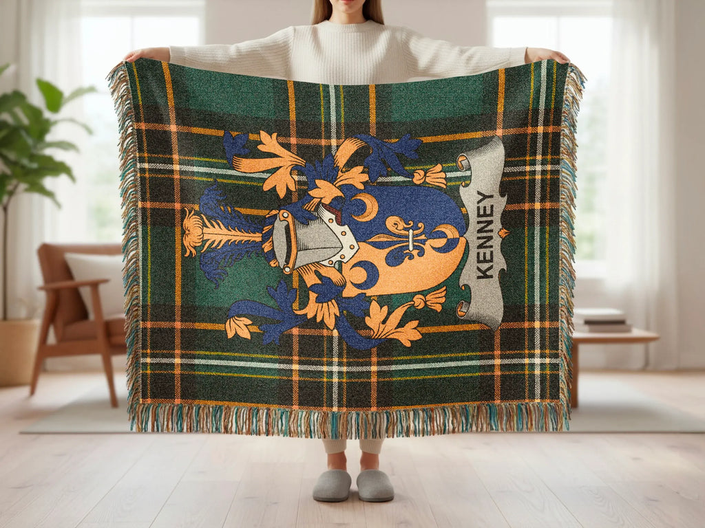 Green and blue plaid throw blanket with orange and blue family crest, text "KENNEY".