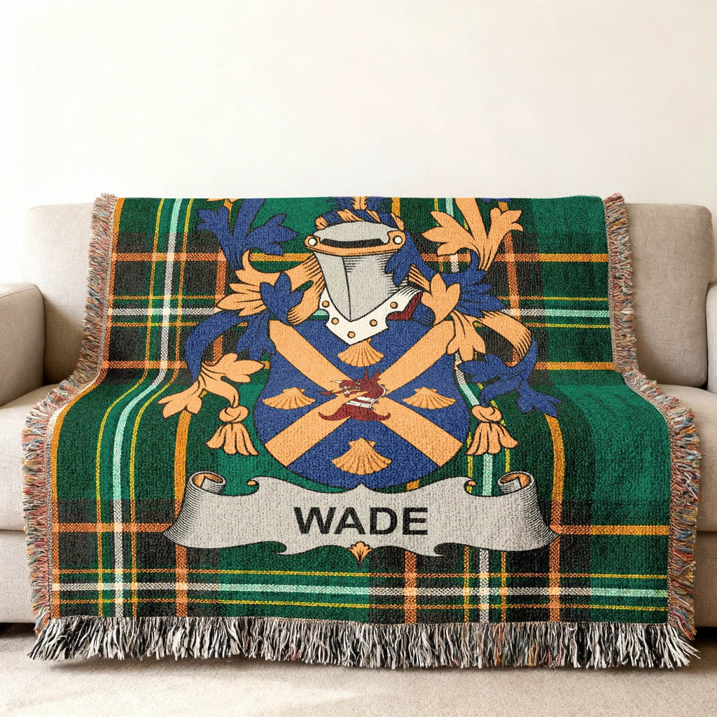 Wade family crest on a green plaid woven throw blanket with fringe.