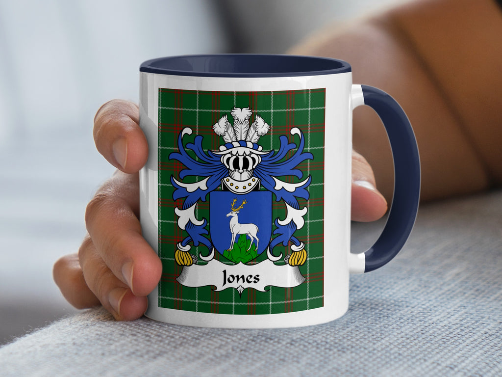 White mug with blue handle displaying the Jones family crest on a green tartan background.