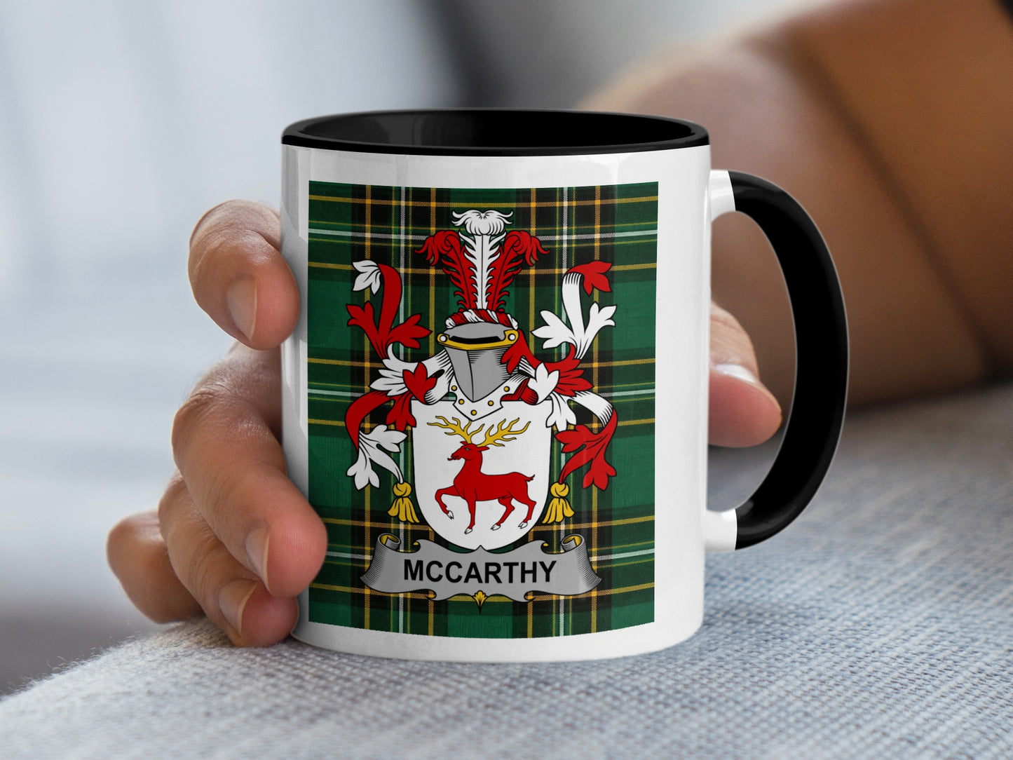 McCarthy crest on a white mug with black interior and handle.