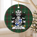Meirion ornament hanging from a pale wooden branch, showing a quartered shield with black-and-white checks and blue crosses on Welsh National Tartan.