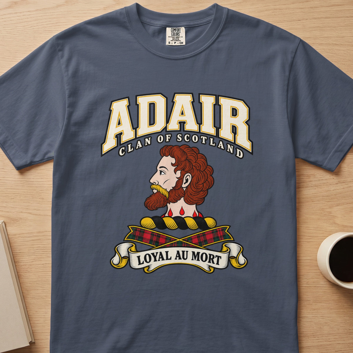 Adair bearded profile crest and tartan ribbons graphic on a slate blue Comfort Colors T-shirt, front view