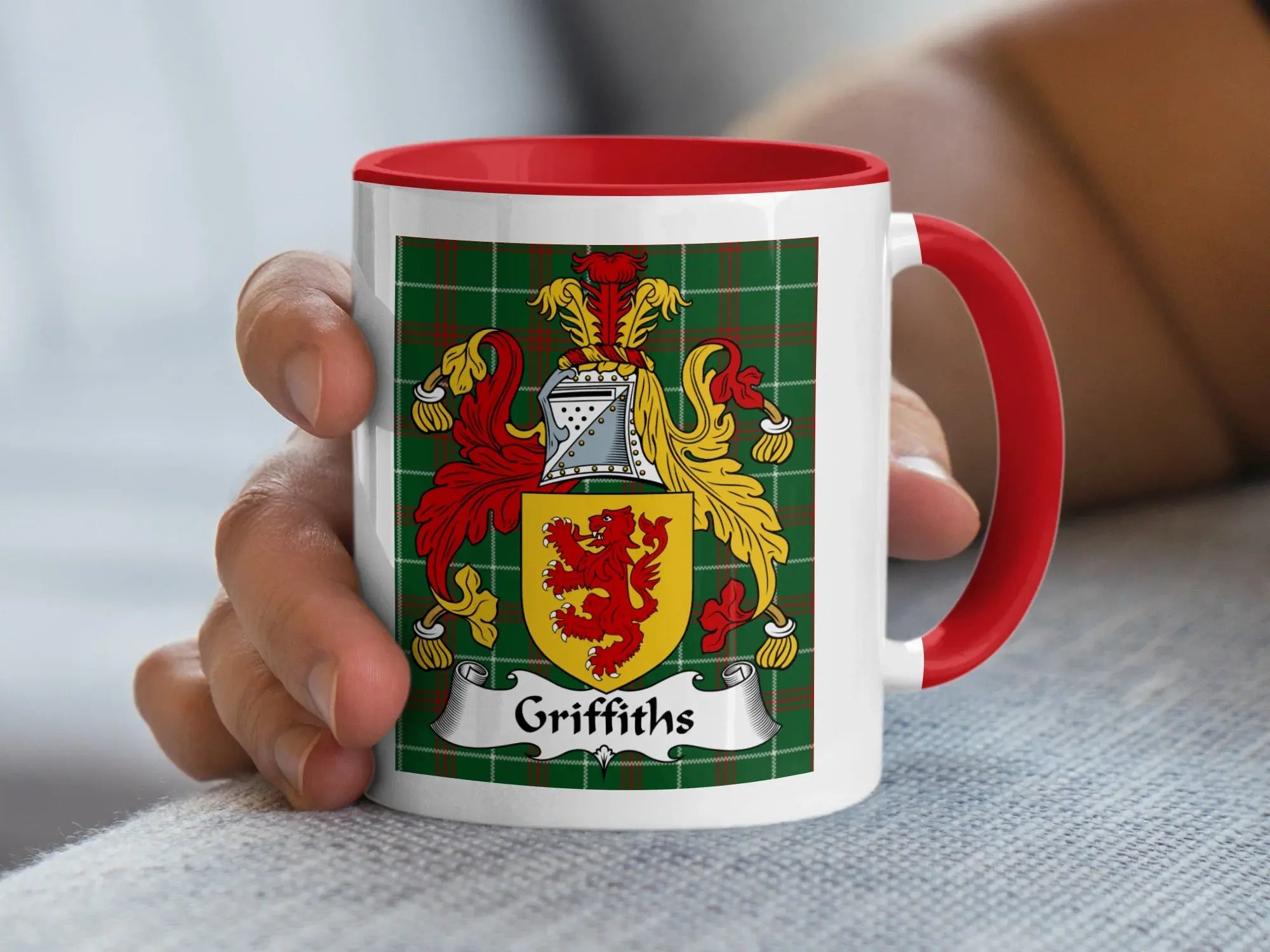 Griffiths Welsh tartan accent mug with red handle held in hand showing family crest