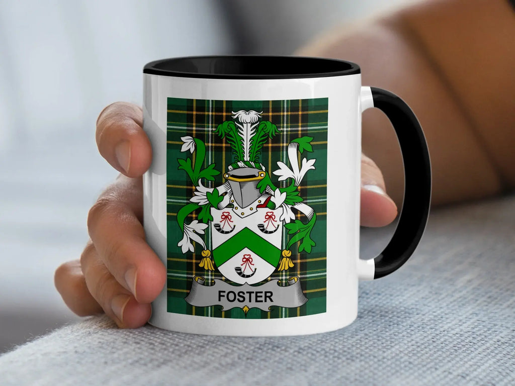 White mug with black rim displaying a green and white plaid crest with the name FOSTER.