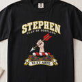 Stephen Scottish clan T-shirt in Black, front view with a hand holding an arrow with red feathers and motto design.