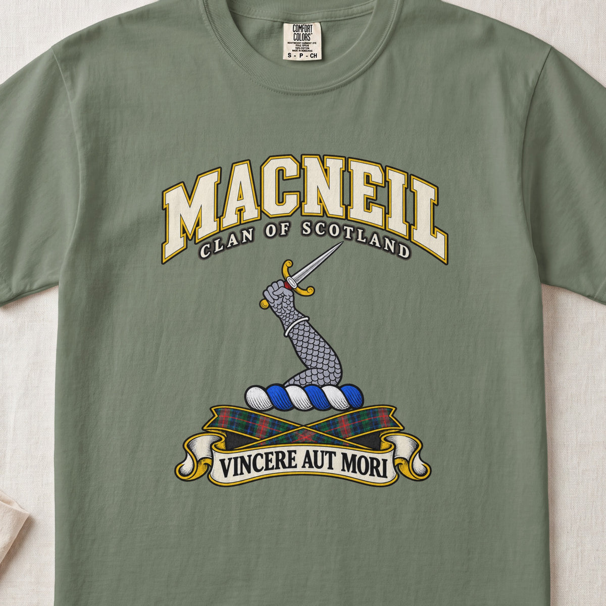 MacNeil Scottish clan T-shirt in Moss, front view with an armoured arm holding a dagger and motto design.