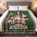 McTiernan family crest on a green tartan plaid blanket on a bed.