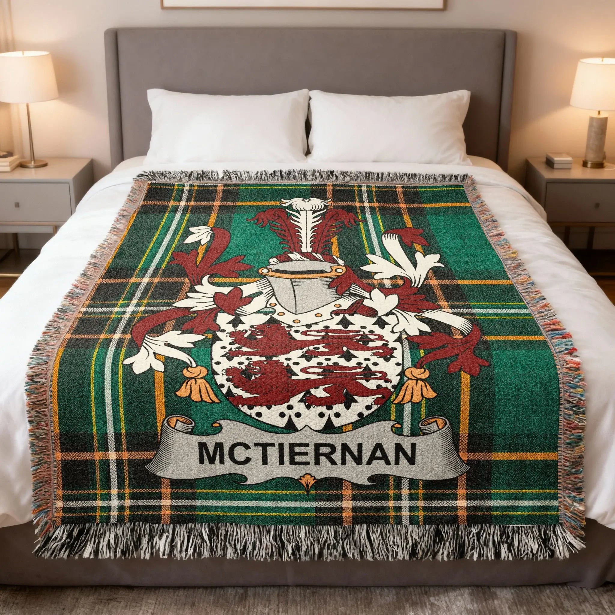 McTiernan family crest on a green tartan plaid blanket on a bed.