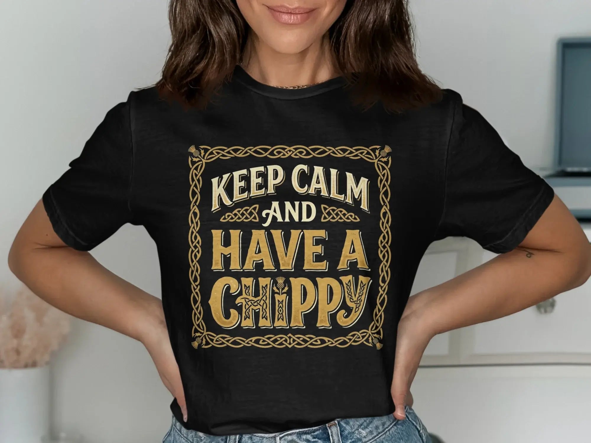 Black t-shirt with gold ornate border and text "Keep Calm and Have a Chippy".