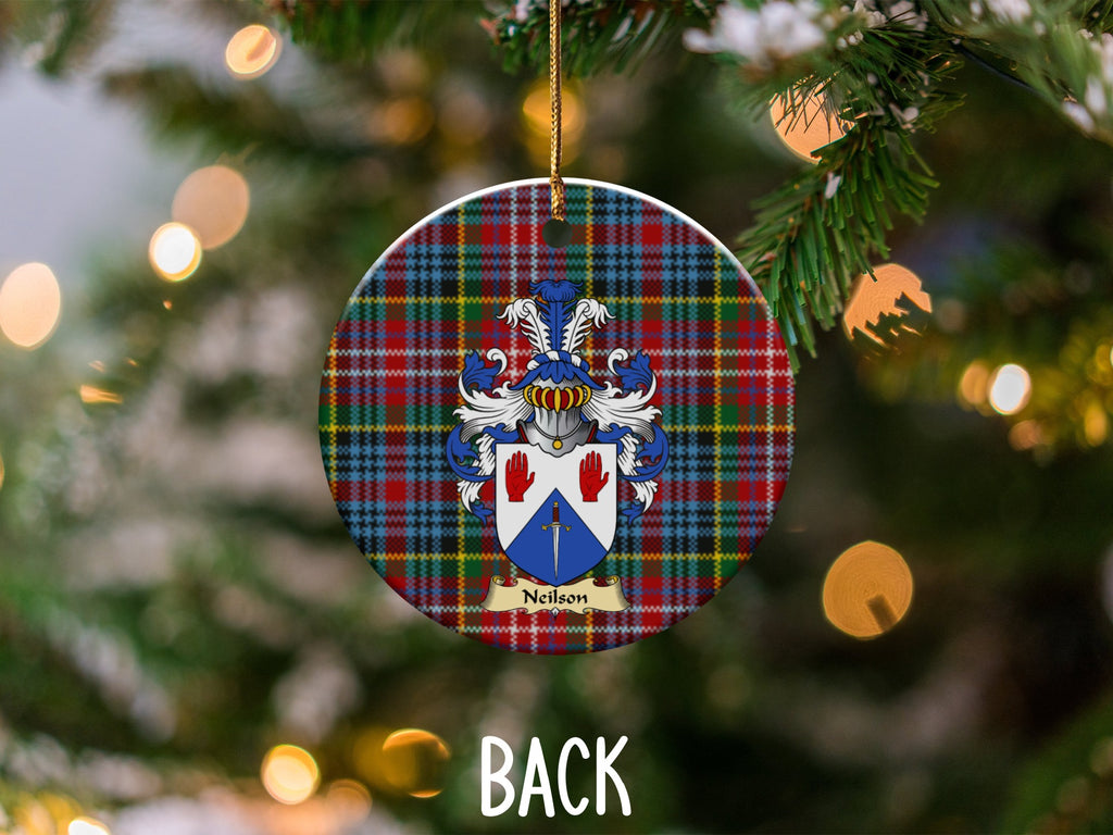 Neilson ceramic ornament detail showing a double-sided family shield on a Caledonia tartan background