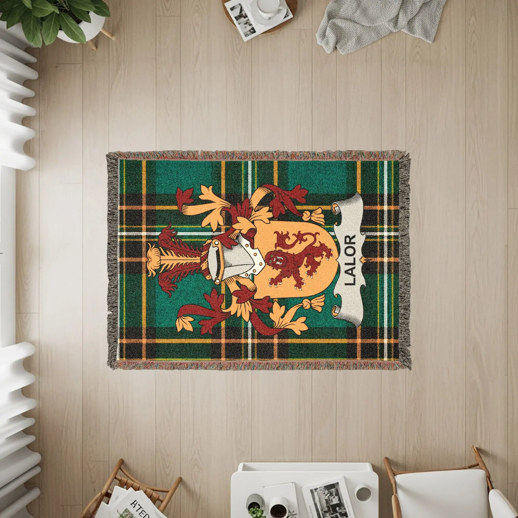 Green plaid throw blanket with LALOR family crest.