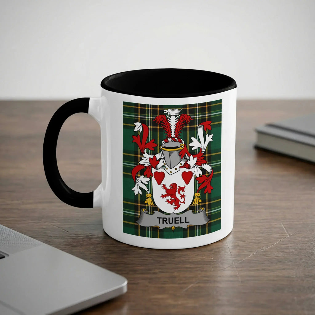 White mug with black rim featuring the Truell family crest on a plaid background.