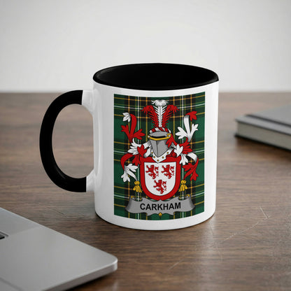 Mug with black handle, featuring the "CARKHAN" family crest on a tartan background.