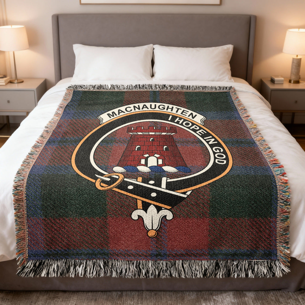 MacNaughten woven blanket displayed on a bed, with a red tower on a green, red and blue tartan background