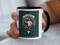 Allardice Scottish family crest artwork on an 11 oz black accent mug with a tartan background