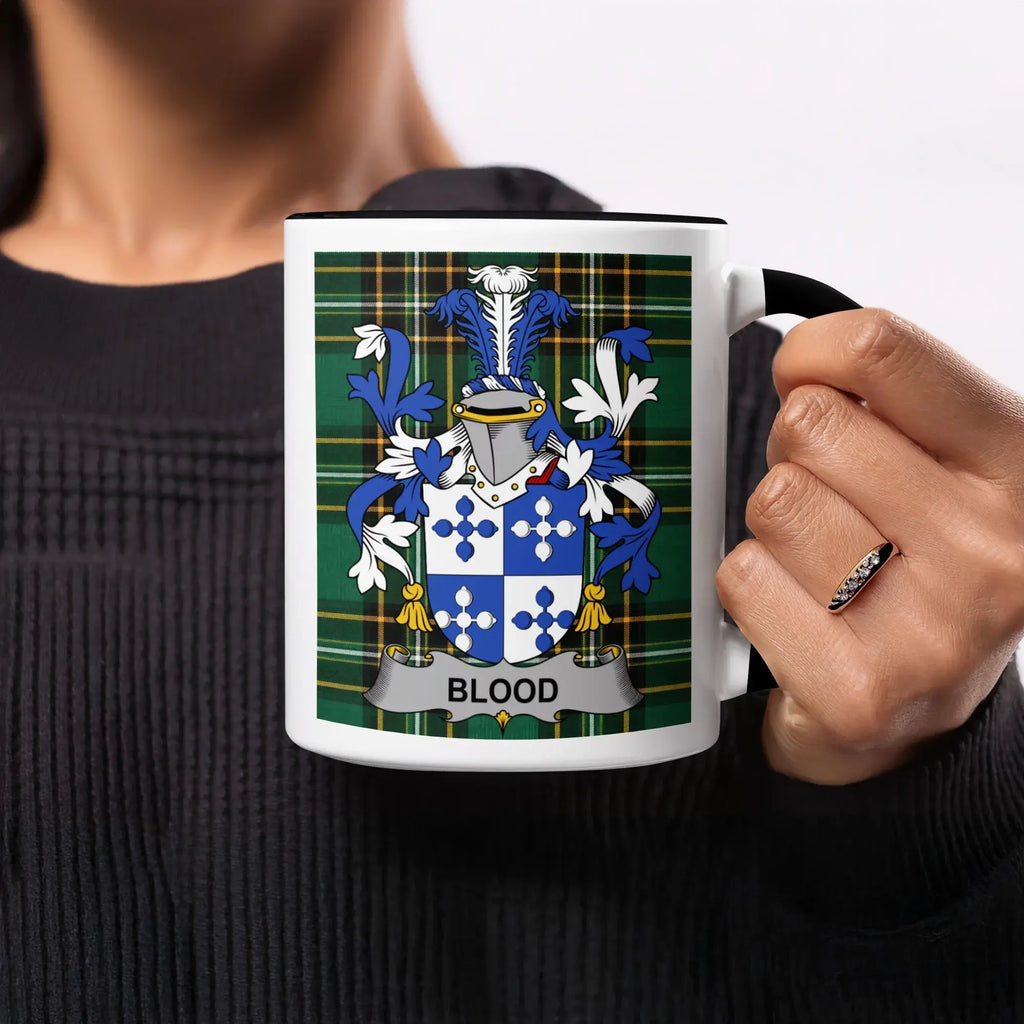 Mug with Blood family crest on green tartan background.