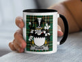 Mug with Power family crest on green plaid background.