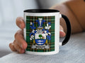 Mug with the Woulfe coat of arms on a plaid background.