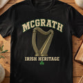 McGrath Irish harp T-shirt in Black, with cream surname lettering, a gold-toned harp, green shamrock and “Irish Heritage” text.