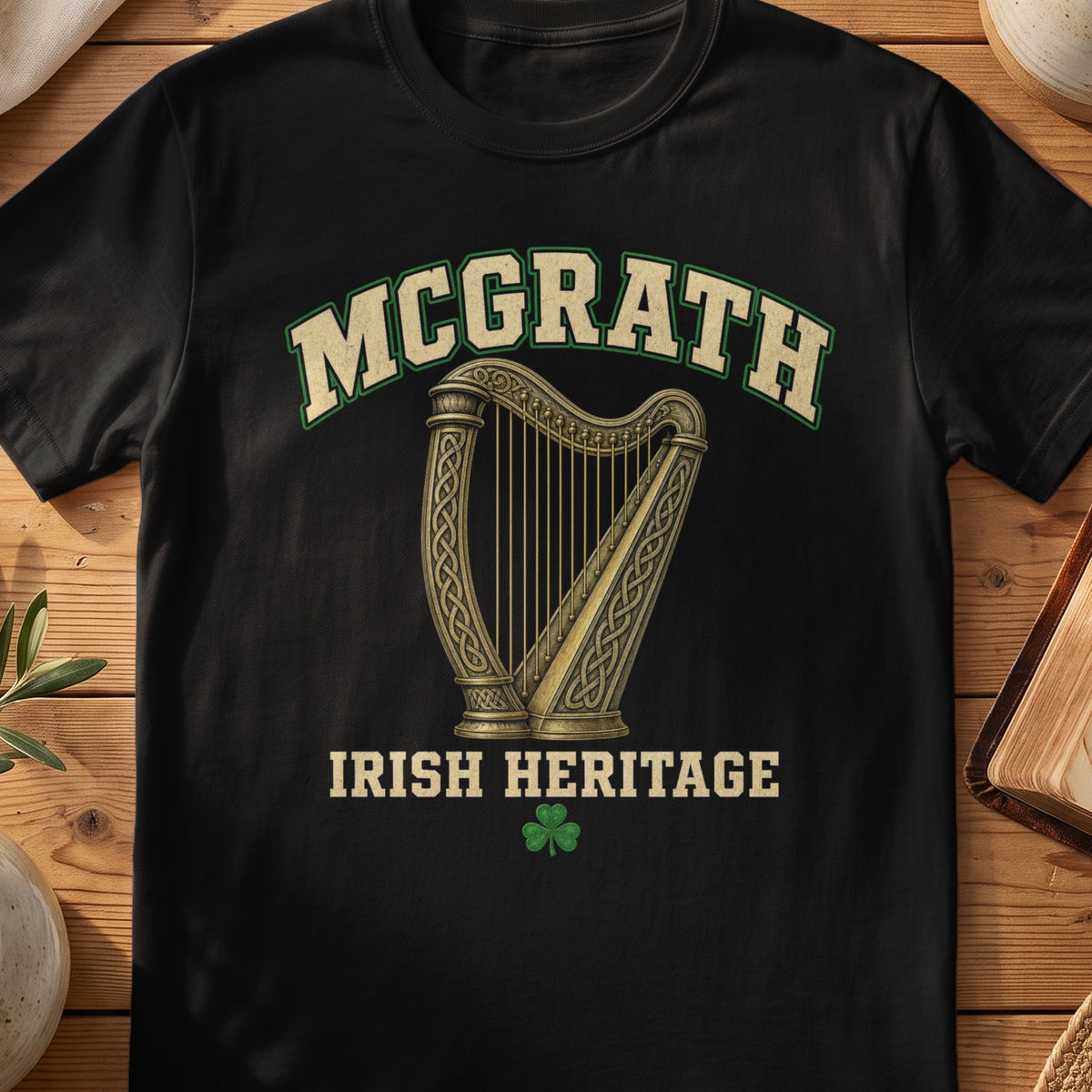 McGrath Irish harp T-shirt in Black, with cream surname lettering, a gold-toned harp, green shamrock and “Irish Heritage” text.