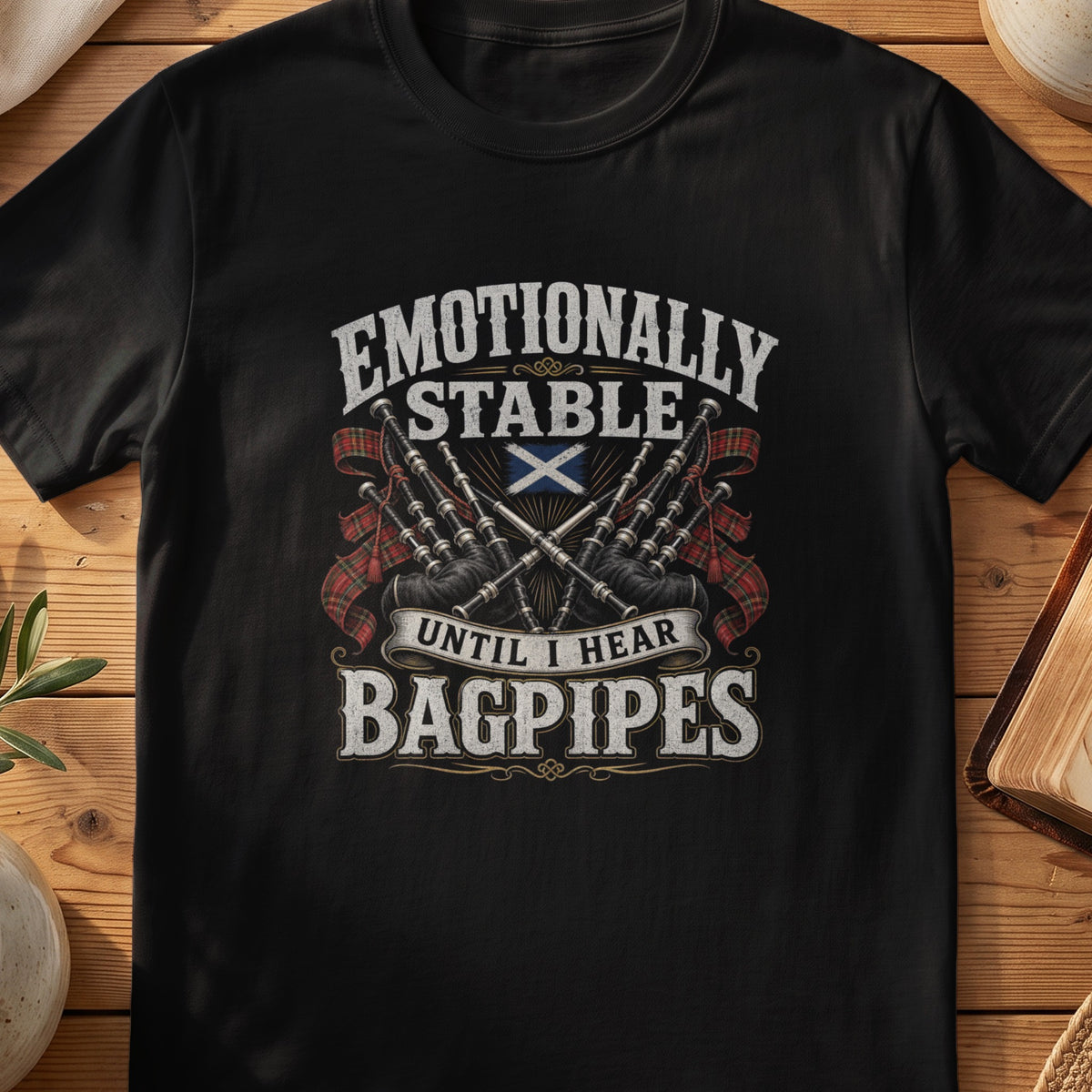 Black Gildan 64000 unisex T-shirt flatlay with Emotionally Stable Until I Hear Bagpipes Scottish graphic design