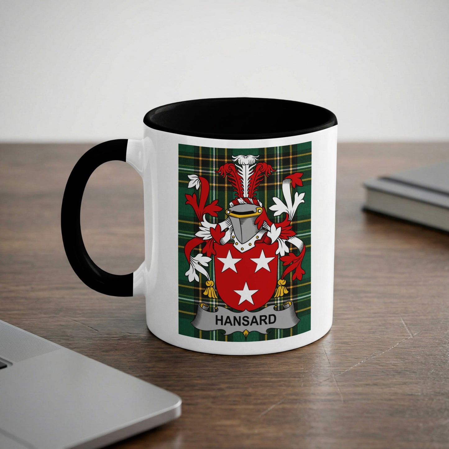 White mug with black rim, featuring the Hansard family crest on a tartan background.