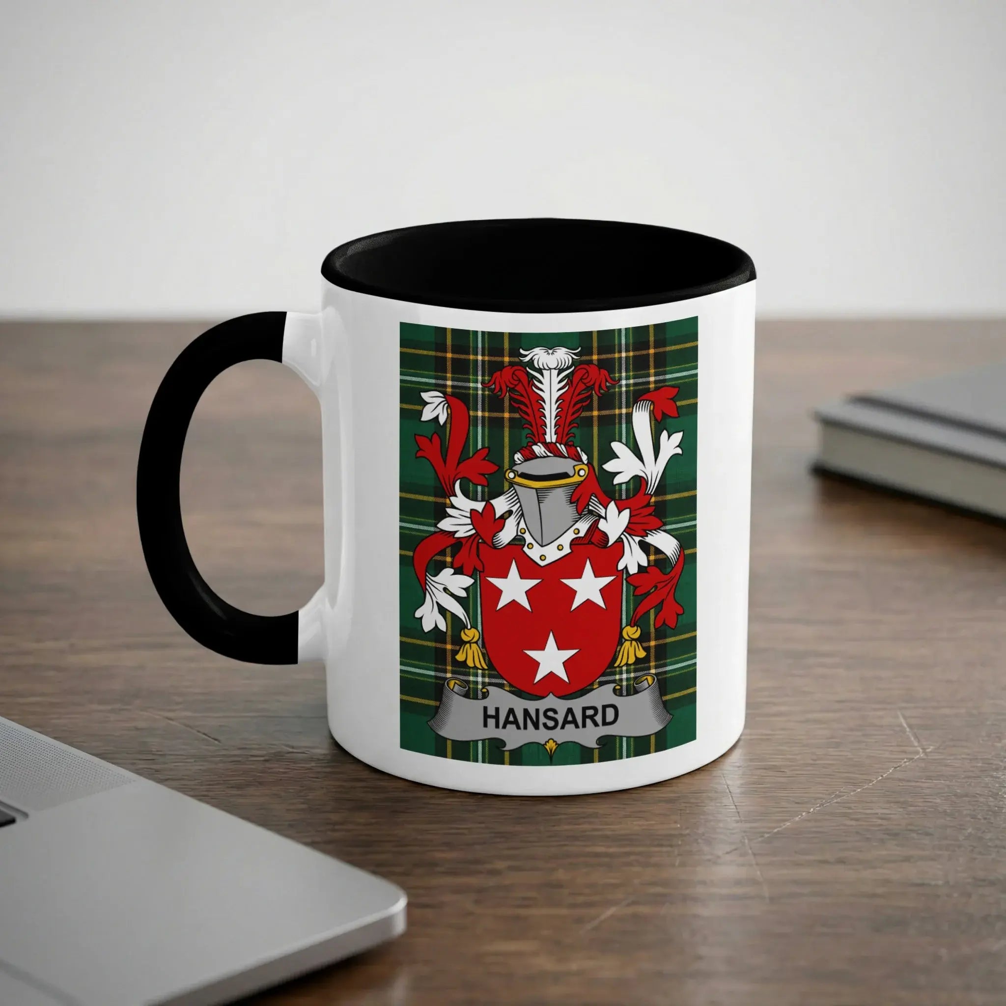 White mug with black rim, featuring the Hansard family crest on a tartan background.