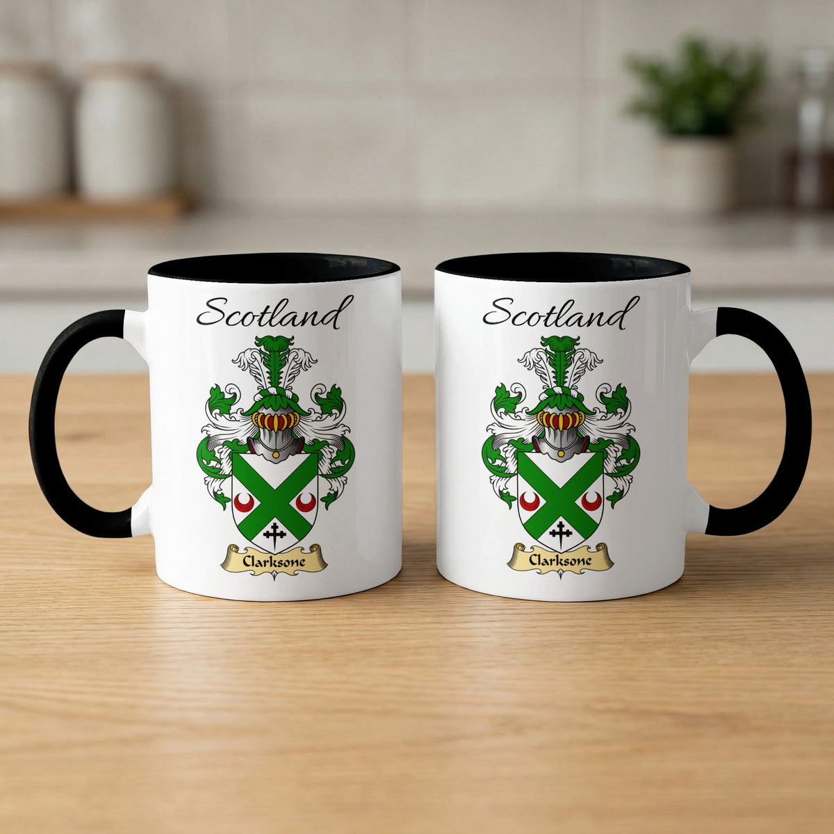 Pair of black-accent Clarkesone mugs showing the double-sided Scottish family shield design on white ceramic.