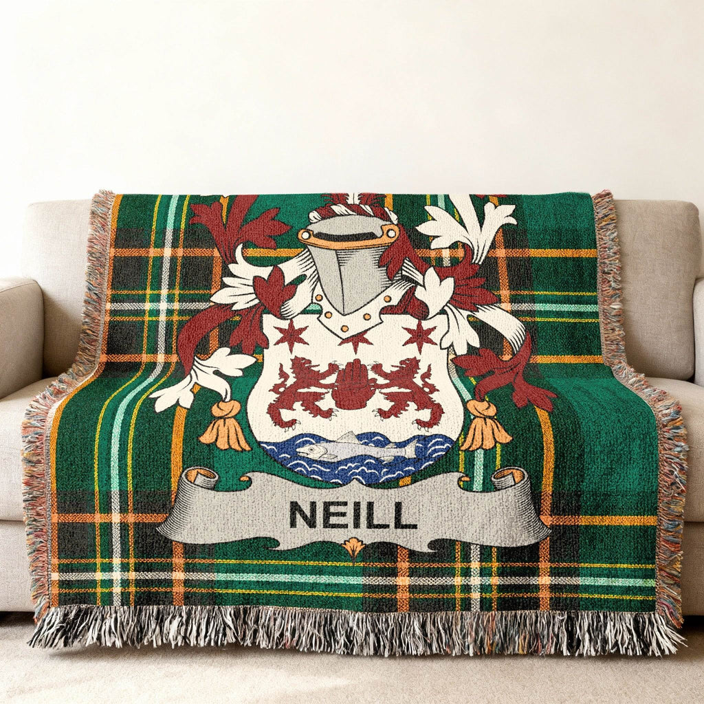 Green tartan throw blanket with a crest and "NEILL" banner.