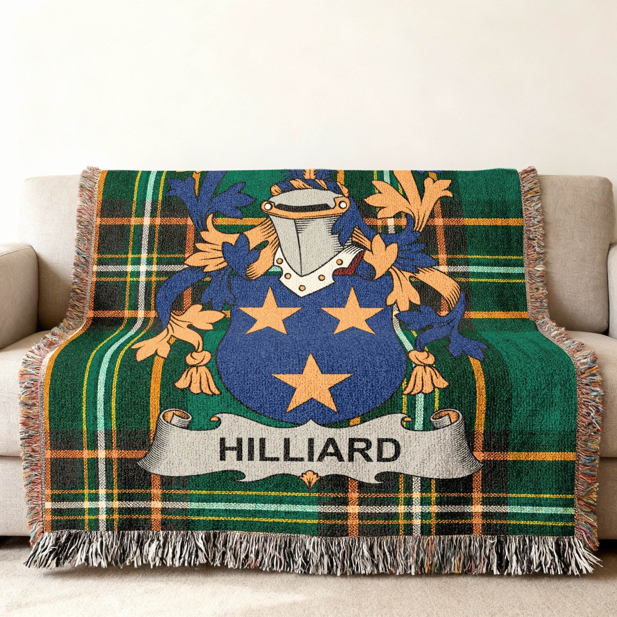 Woven blanket with Hilliard family crest and green plaid design.