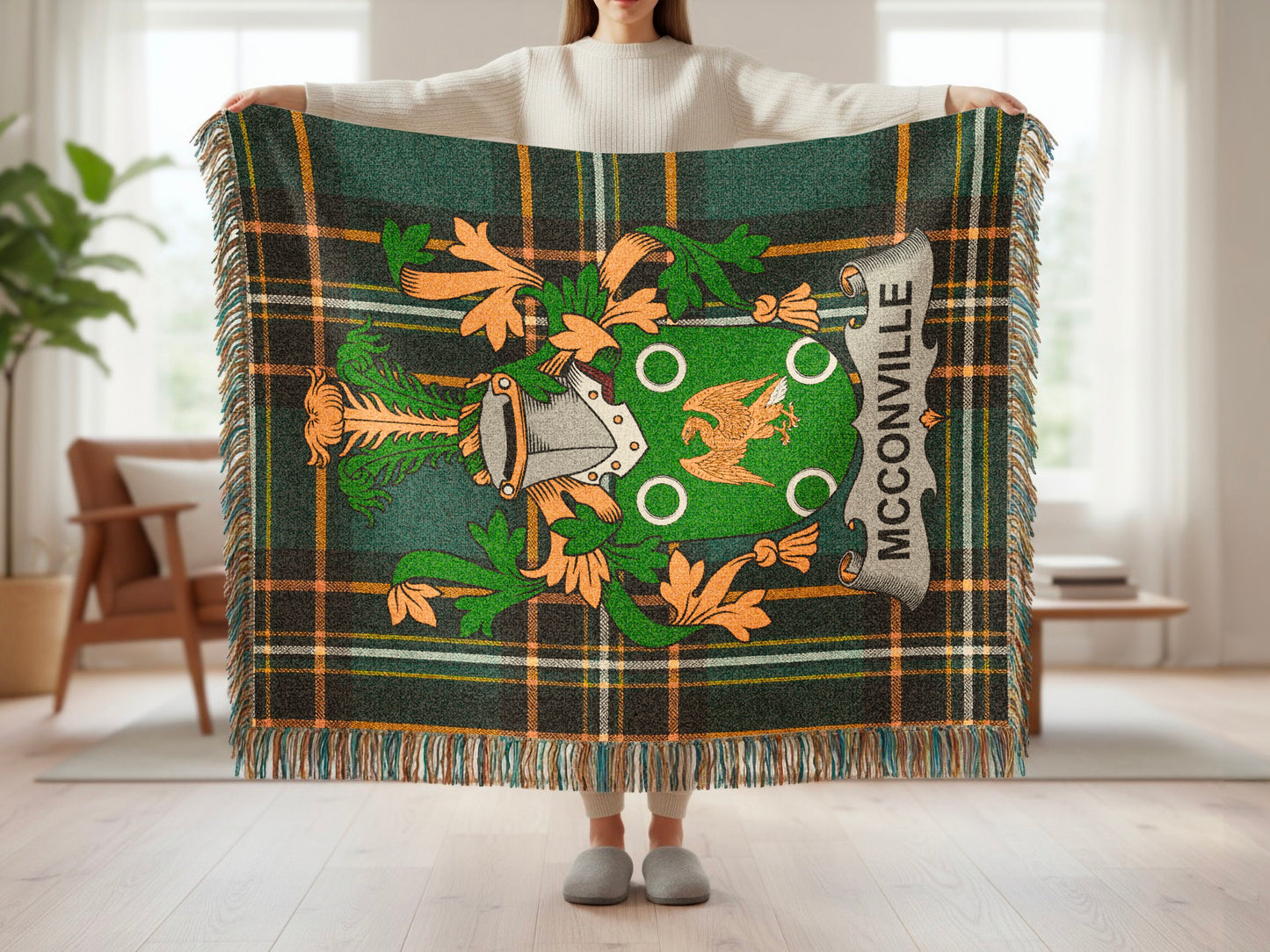 Green tartan blanket with McCARTHY crest and fringe held by a person.