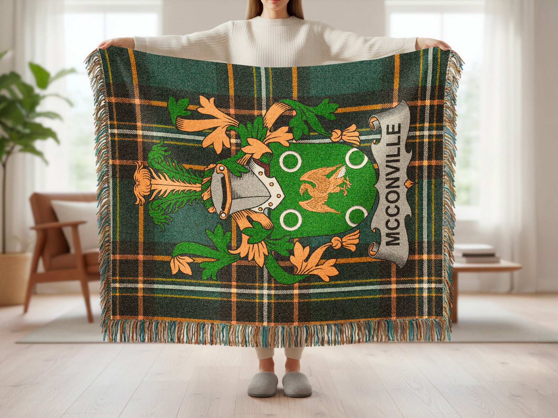 Green tartan blanket with McCARTHY crest and fringe held by a person.