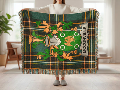 Green tartan blanket with McCARTHY crest and fringe held by a person.