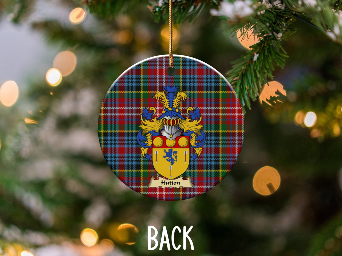 Hutton ceramic ornament detail showing a double-sided family shield on a Caledonia tartan background