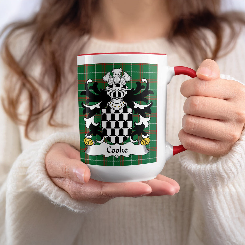 White mug with red handle featuring Cooke family crest on tartan background.