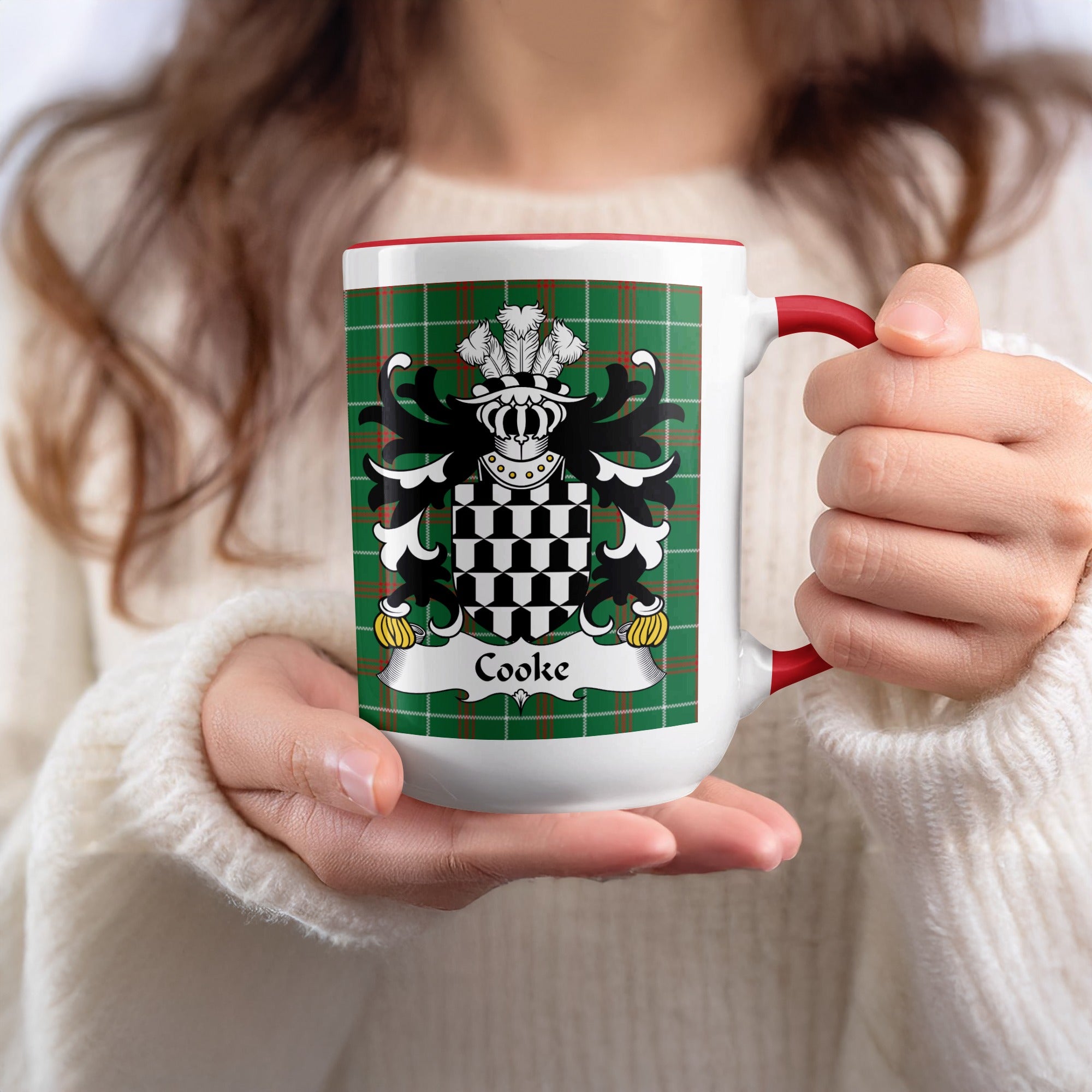 White mug with red handle featuring Cooke family crest on tartan background.