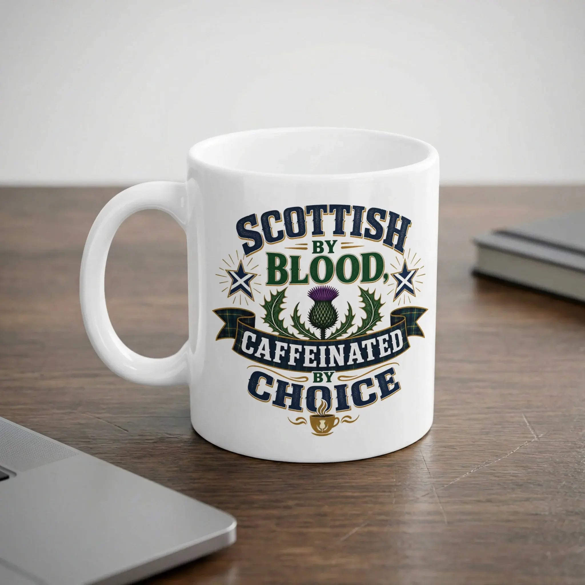 White mug with "Scottish by Blood, Caffeinated by Choice" text and thistle.