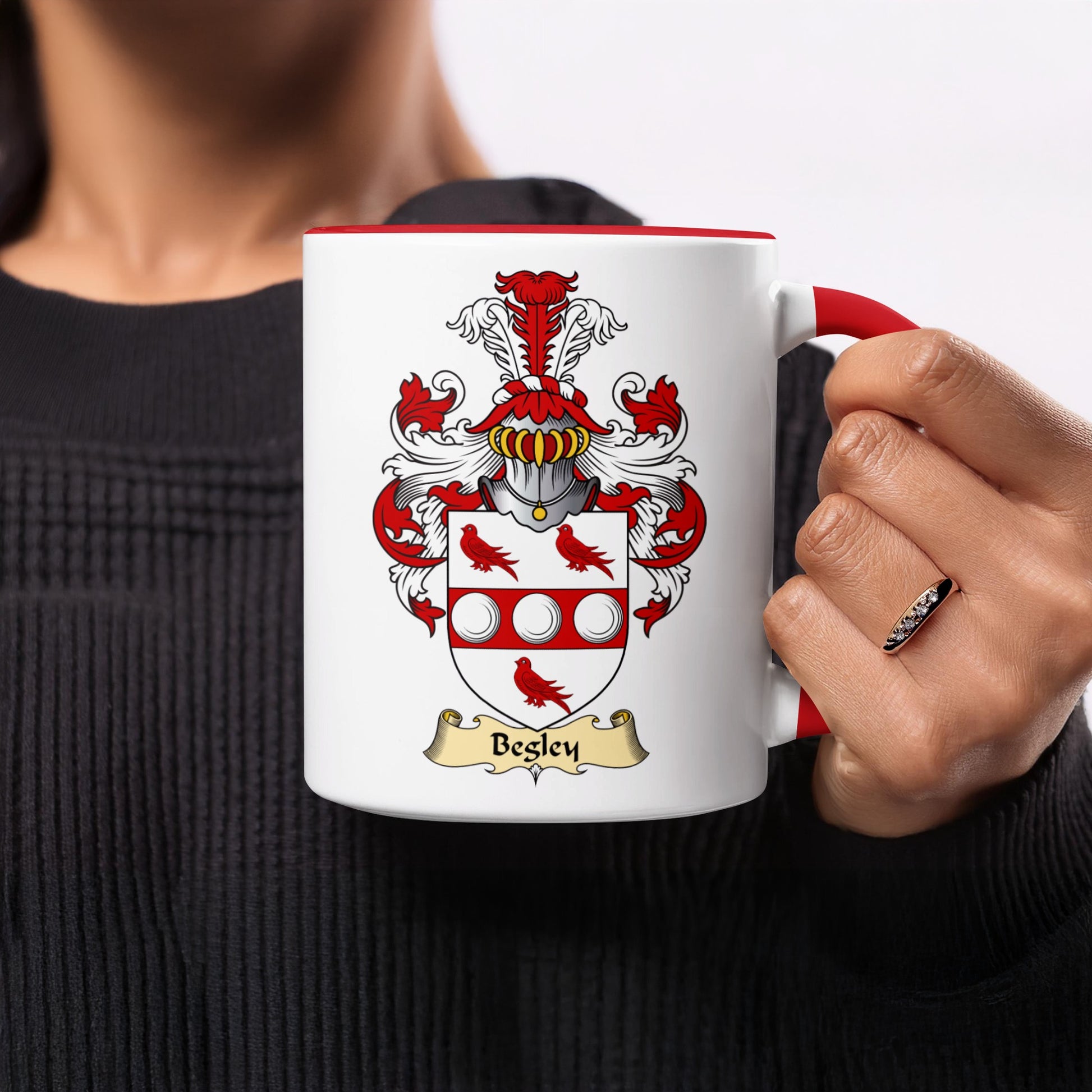 White mug with red rim featuring the Besley family crest and name.